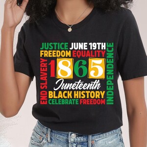 May include: Black t-shirt with a colorful graphic design. The design includes the words "Justice, Freedom, Equality, Independence, Black History, Celebrate Freedom" and the number "1865" with the word "Juneteenth".
