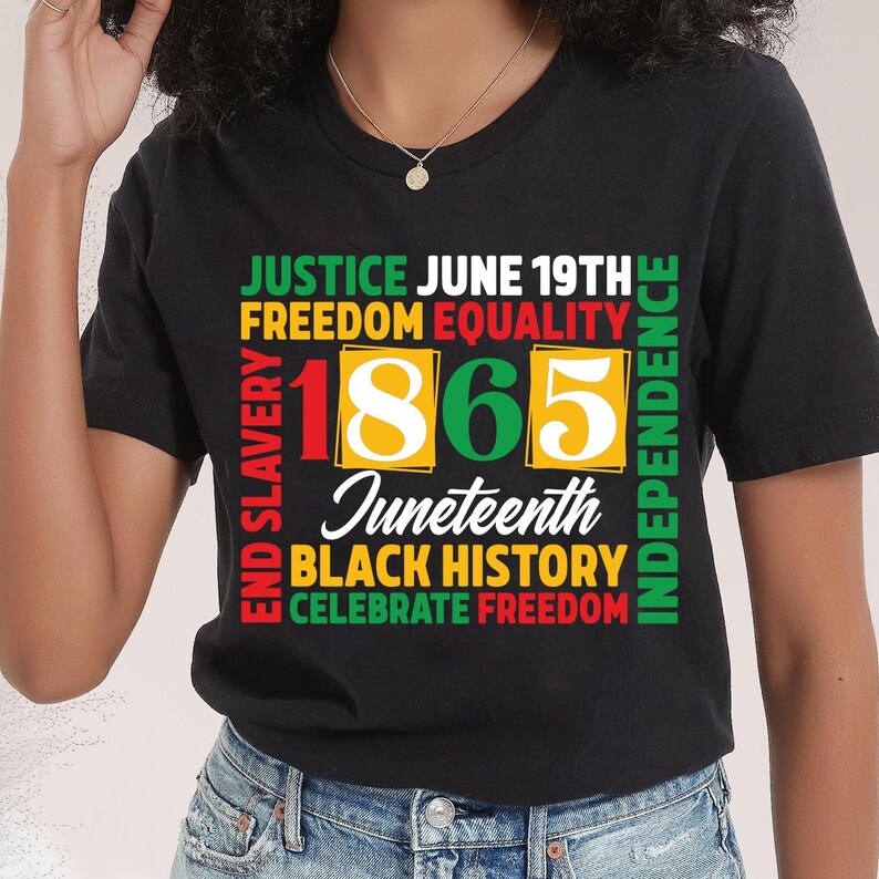 May include: Black t-shirt with a colorful graphic design. The design includes the words "Justice, Freedom, Equality, Independence, Black History, Celebrate Freedom" and the number "1865" with the word "Juneteenth".