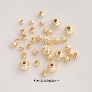 May include: A collection of gold-colored round beads with a faceted, spiral-cut texture. The beads vary in size, and the text "Size:3/4/5/6/8mm" is printed at the bottom. These metallic components are designed for jewelry making and crafting projects.