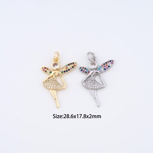 May include: Two fairy pendants, one gold-toned and one silver-toned, each with a sparkling dress and wings adorned with colorful gems. The pendants measure 28.6 x 17.8 x 2mm.