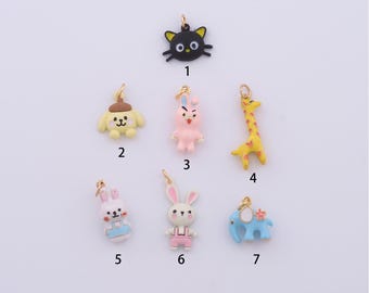 May include: Seven colorful enamel charms with gold-tone jump rings. The charms feature a black cat, a yellow dog, a pink bunny, a yellow giraffe, a white bunny, a pink bunny, and a blue elephant.