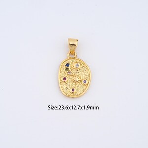 May include: Gold-colored pendant with an oval shape, featuring a crescent moon, stars, and colorful gemstones. The pendant measures 23.6mm x 12.7mm x 1.9mm. The design includes a textured surface and a loop for a chain.