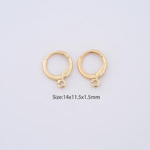 May include: Two gold-toned earring hoops with a small loop at the bottom. Size: 14x11.5x1.5mm