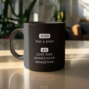 May include: Black coffee mug with white text that reads "GOD has a plan" and "AI just has predictive analytics".
