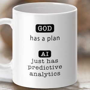 May include: White ceramic coffee mug with black text that reads "GOD has a plan" and "AI just has predictive analytics".