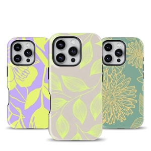 May include: Three phone cases with floral designs. The cases feature a variety of colors, including purple, green, and beige. The designs include flowers and leaves. The cases are made of a hard plastic material.