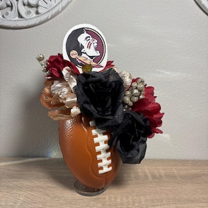 Celebrate garnet and gold with this Florida State Seminoles floral football arrangement!