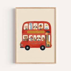 May include: A framed wall art print featuring a red double-decker bus filled with various illustrated animals including a bear, giraffe, fox, and dog. The bus has black wheels and a light cream background. The artwork is enclosed in a light wood frame.
