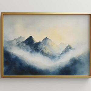 May include: A framed watercolor painting of a mountain range with a misty, foggy background. The mountains are a dark blue color, and the sky is a light blue with a hint of yellow.