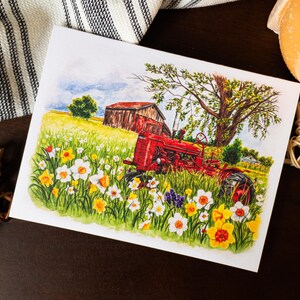 May include: Watercolor painting of a red tractor in a field of yellow and white daffodils. A red barn and a large tree are in the background under a blue sky. The artwork is on a white card.