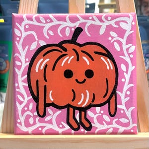 May include: A hand-painted canvas featuring a cartoon pumpkin with a smiling face and a pink background with white vines.