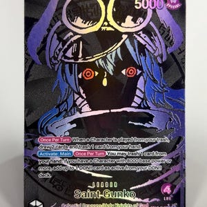 May include: A Saint-Gunko trading card featuring a holographic purple and black design. The card displays a character with goggles, red eyes, and text detailing game abilities, including Once Per Turn and Activate: Main, with a 5000 power level.