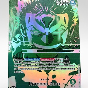 May include: A holographic trading card featuring Roronoa Zoro from the Supernovas/Straw Hat Crew. The card has a green and silver color scheme with the number 5000 and the word "SLASH" at the top. Text on the card includes "DON!!x3 Activate: Main Once Per Turn" and "LIFE".
