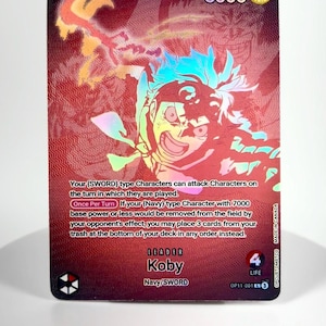 May include: A trading card featuring Koby from the Navy/SWORD faction. The card has a red and gold background with a character illustration. Text includes "5000", "Leader", and card abilities.