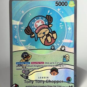 May include: A holographic One Piece trading card featuring Tony Tony Chopper as a leader. The card displays a power level of 5000, a life value of 4, and text detailing game mechanics. The artwork shows a cartoon character in a blue hat.