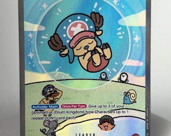 May include: A holographic One Piece trading card featuring Tony Tony Chopper as a leader. The card displays a power level of 5000, a life value of 4, and text detailing game mechanics. The artwork shows a cartoon character in a blue hat.