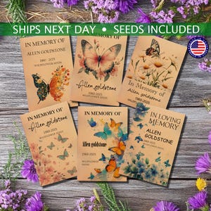 May include: A collection of wildflower seed packets with butterfly and floral designs. Each packet features the text "In Memory of Allen Goldstone 1960-2025 Wildflower Seeds." The packets are arranged on a wooden surface with purple flowers.