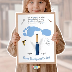 May include: A framed print with a light wood frame, featuring a blue footprint, tools, and the text "Happy Grandparent's day!". The print includes a heart with the name "Saylar" and a poem about a grandparent.