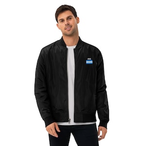 May include: A black bomber jacket with a zipper closure and a small embroidered flag of Argentina with the text "ARG" above it.
