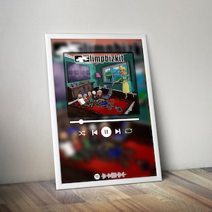 May include: A framed print featuring a cartoon illustration of a room with a red rug and a woman vacuuming. The print has a music player interface at the bottom and the text "Limp Bizkit" at the top.