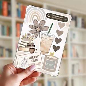 May include: A clear phone case with a collage of stickers. The stickers include a rainbow, a large flower, a coffee cup, hearts, a stack of books, a library card, a candle, and the text "Do Not Disturb Reading Mode" and "Books".