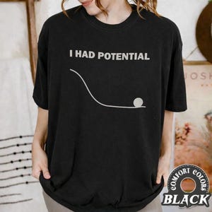 May include: A white ceramic mug with a black handle and the text "But First, Coffee" in a handwritten style. The mug is on a white surface. The mug is 4 inches tall.