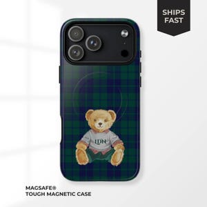 May include: A tough magnetic phone case with a green and navy plaid design. The case features a teddy bear wearing a sweater with "LDN" on it. The case is designed for MagSafe.