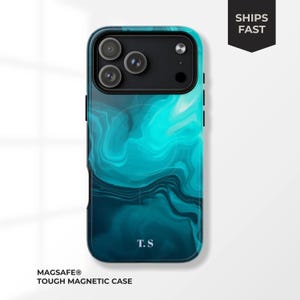 May include: A teal and navy blue phone case with a swirling abstract design. The case has a black camera module and the initials "T.S" at the bottom. The case is labeled "MAGSAFE® TOUGH MAGNETIC CASE" and has a "SHIPS FAST" graphic.