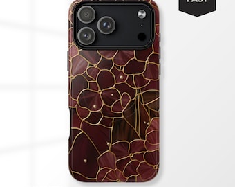 May include: A burgundy phone case with a floral design and gold accents. The case has a glossy finish and features a pattern of stylized flowers with gold outlines and small gold embellishments. The phone case has the text "MAGSAFE®".