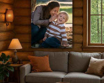 May include: A framed canvas print featuring a woman whispering to a young child. The child is laughing, wearing a brown and white striped sweater and blue jeans. The woman is wearing a brown long-sleeve shirt and blue jeans. The background is a natural outdoor setting.