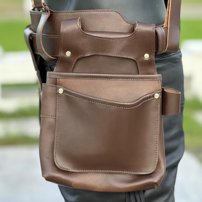 Close-up of full-grain brown leather texture with precision stitching, highlighting handmade craftsmanship.