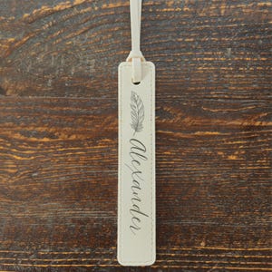 May include: A rustic wooden sign with the text "Welcome to our home" in white lettering. The sign features a distressed finish and a simple, inviting design, perfect for entryway decor.