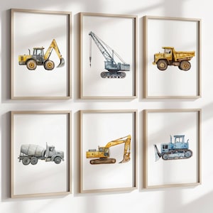 May include: Six framed watercolor prints of construction vehicles. The prints feature a yellow excavator, a crane, a dump truck, a cement mixer, a yellow excavator, and a blue bulldozer. Each print is in a light wood frame.