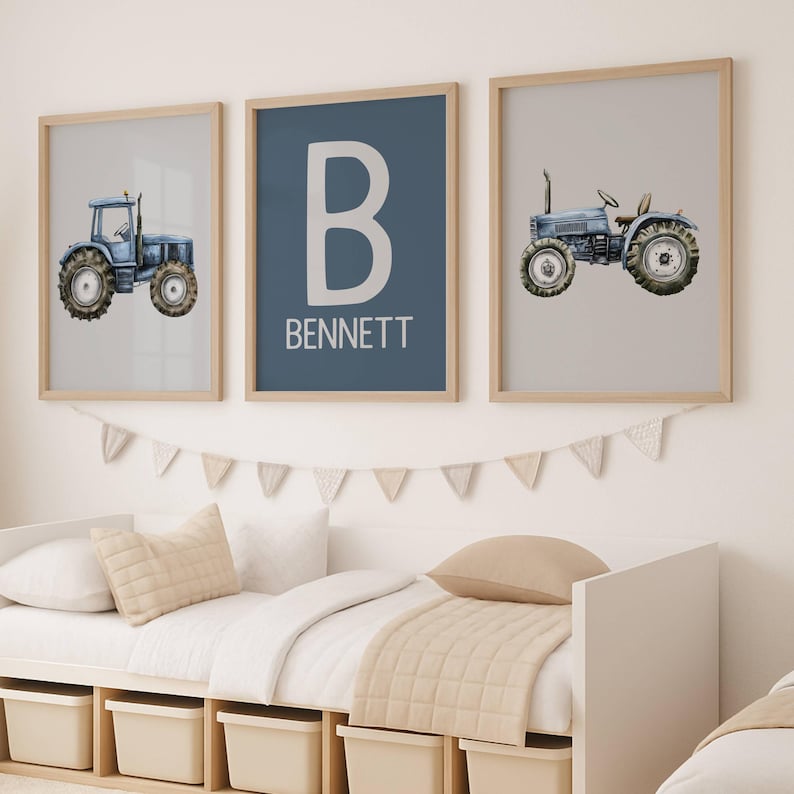 May include: Three framed prints with a farm theme. Two prints feature blue watercolor tractors on light backgrounds. The center print has a large white "B" and the name "BENNETT" on a blue background. The frames are light wood.