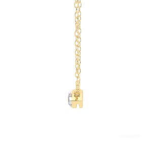 May include: A delicate gold necklace featuring a small, round, clear gemstone pendant. The pendant is set in a gold bezel and hangs from a fine gold chain. The necklace is displayed against a white background.