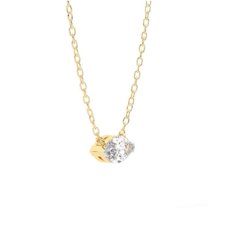 May include: A delicate gold necklace featuring a small, sparkling diamond pendant. The pendant is a square shape with a clear, faceted stone set in a gold and silver setting. The chain is a fine link design.