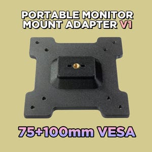 May include: A black portable monitor mount adapter V1 with a central brass-colored threaded insert. The square-shaped mounting plate features multiple holes for 75mm and 100mm VESA compatibility, as indicated by the text 75+100mm VESA.