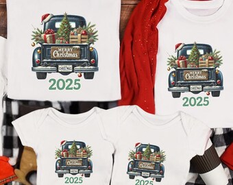May include: White t-shirts and onesies with a Christmas truck graphic, paired with black and white plaid pajama pants. The truck is carrying a Christmas tree and gifts, with the year 2025 printed below.