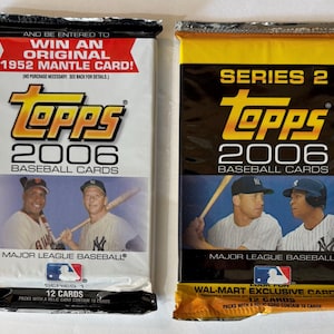 May include: Two sealed packs of 2006 Topps baseball cards. The left pack is white, featuring Series 1, 12 cards, and a promotion to win a 1952 Mantle card. The right pack is black and yellow, labelled Series 2, 12 cards, and Wal-Mart exclusive.