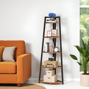 May include: A corner bookshelf with five wooden shelves and a black metal frame. The shelves hold books, framed pictures, a clock, a camera, and decorative boxes. A blue flower arrangement sits on the top shelf.