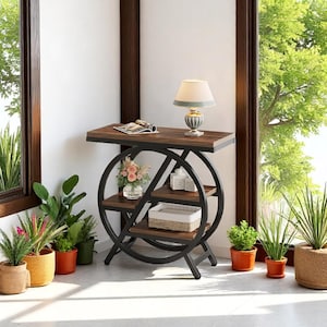 May include: A decorative, dark wood and black metal side table with three shelves. The table has a circular design with a rectangular top. A lamp, flowers, and decorative items are displayed on the table.