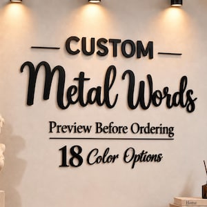 May include: Black dimensional wall lettering reading CUSTOM Metal Words, Preview Before Ordering, and 18 Color Options. The text is mounted on a light-colored wall above a wooden surface, accompanied by a white bust sculpture and stacked books.