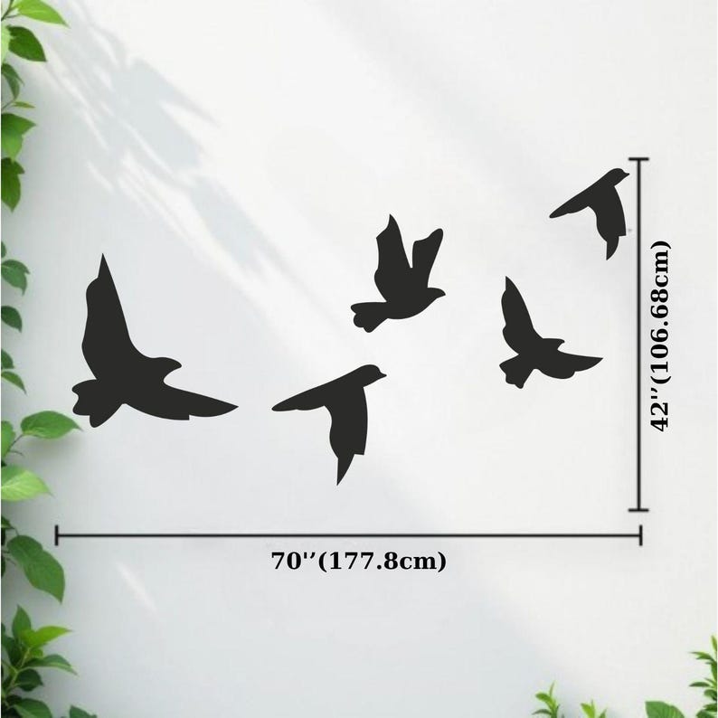 May include: Black silhouette of five birds in flight, arranged on a white wall. The artwork spans 70 inches (177.8cm) wide and 42 inches (106.68cm) high. The birds are depicted with outstretched wings, creating a sense of movement and freedom.