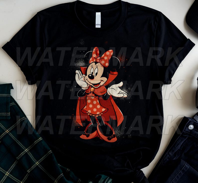May include: A black short-sleeved t-shirt featuring a graphic of a cartoon mouse character dressed as a vampire. The character wears a red polka-dot dress, a matching bow, and a red cape, with white gloves and shoes against a dark background.