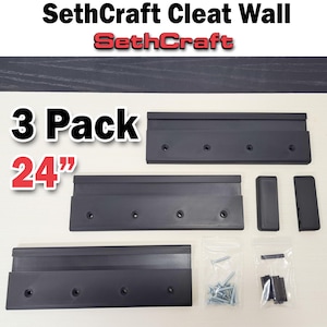 May include: A black cleat wall system by SethCraft. The image shows a 3-pack of 24-inch (61 cm) black cleats, along with mounting hardware. The product name "SethCraft Cleat Wall" is displayed at the top of the image.