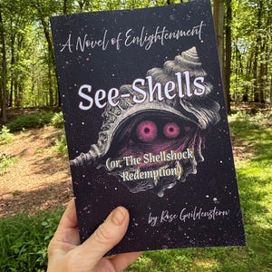 May include: A paperback book titled See-Shells (or, The Shellshock Redemption) by Rose Guildenstern, A Novel of Enlightenment. The black cover features a detailed illustration of a seashell with two glowing pink eyes and white text.