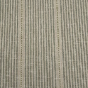 May include: A woven fabric featuring a repeating pattern of vertical stripes in muted sage green and light beige. The design consists of alternating thin solid lines and slightly wider dotted lines, creating a textured, linear appearance.