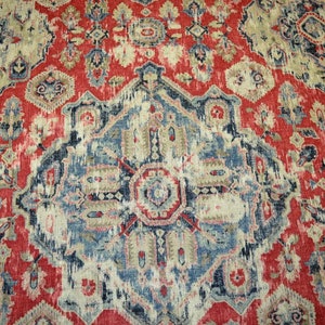 May include: A red, blue, and beige patterned rug with a central medallion design. The rug has a distressed, vintage look.