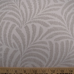 May include: White fabric with a gray leaf pattern. The fabric has a subtle texture and a slightly off-white background.