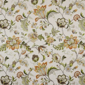 May include: A white fabric with a floral pattern in shades of green, brown, and orange. The pattern features stylized flowers, leaves, and vines.